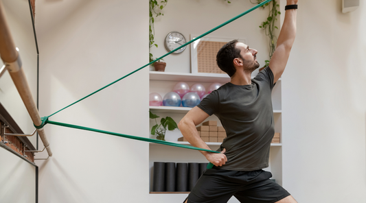 A male performing resistance bands exercises with safety.