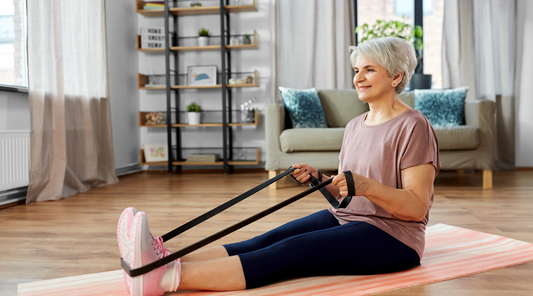 Elderly woman prioritizing senior fitness with resistance bands.